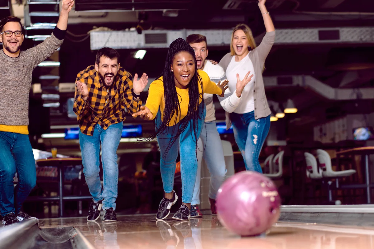 Group of friends enjoying time together while bowling