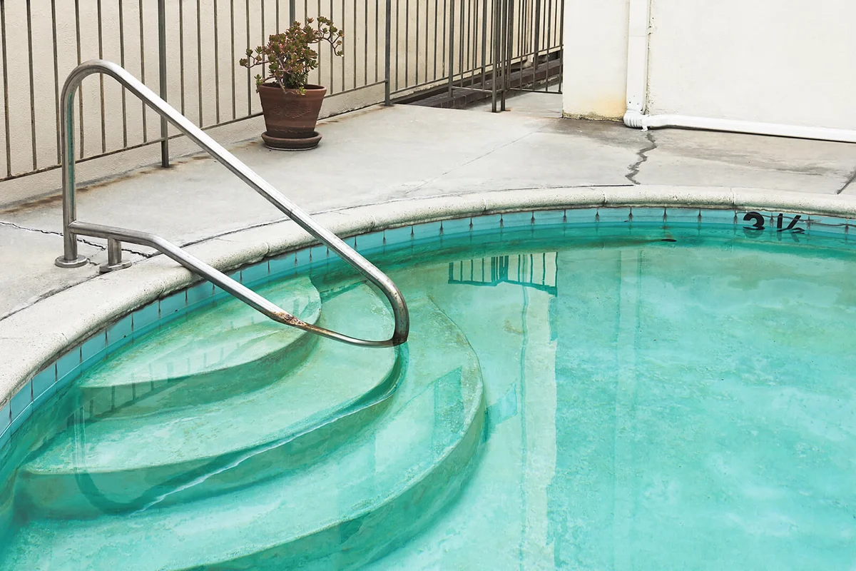 Swimming pool is old and dirty.