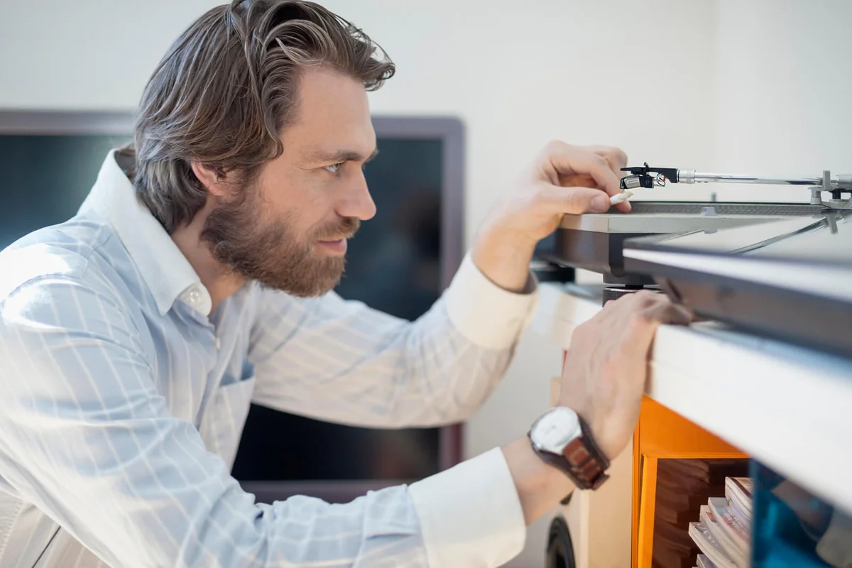 bearded man at home with hifi equipment