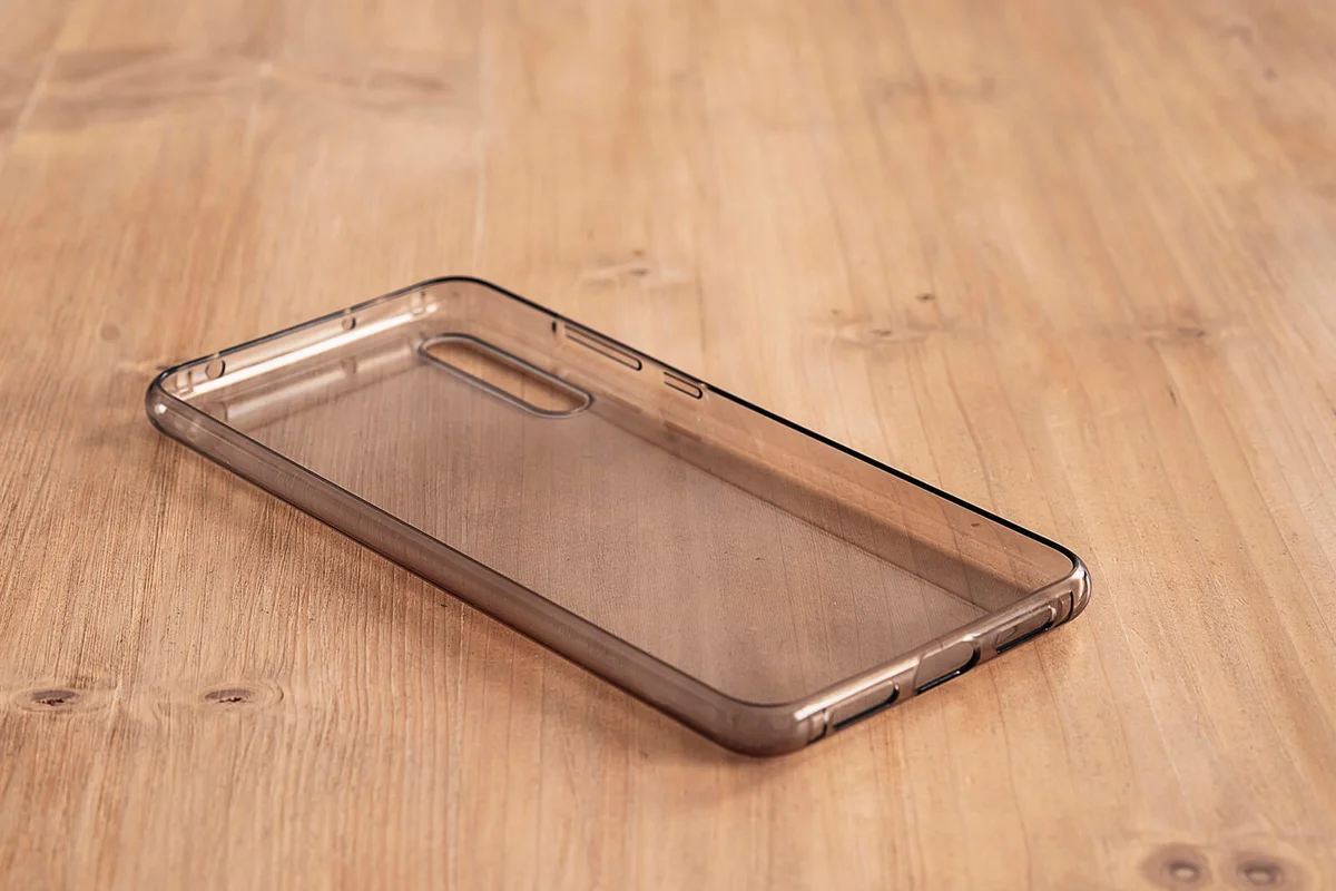 oft transparent mobile case in a light wood table