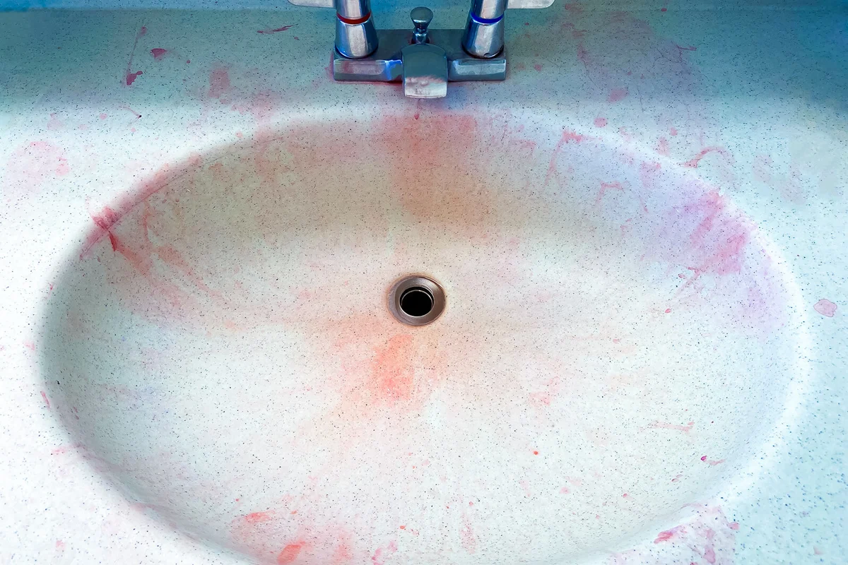 Red hair dye stains left in bathroom sink