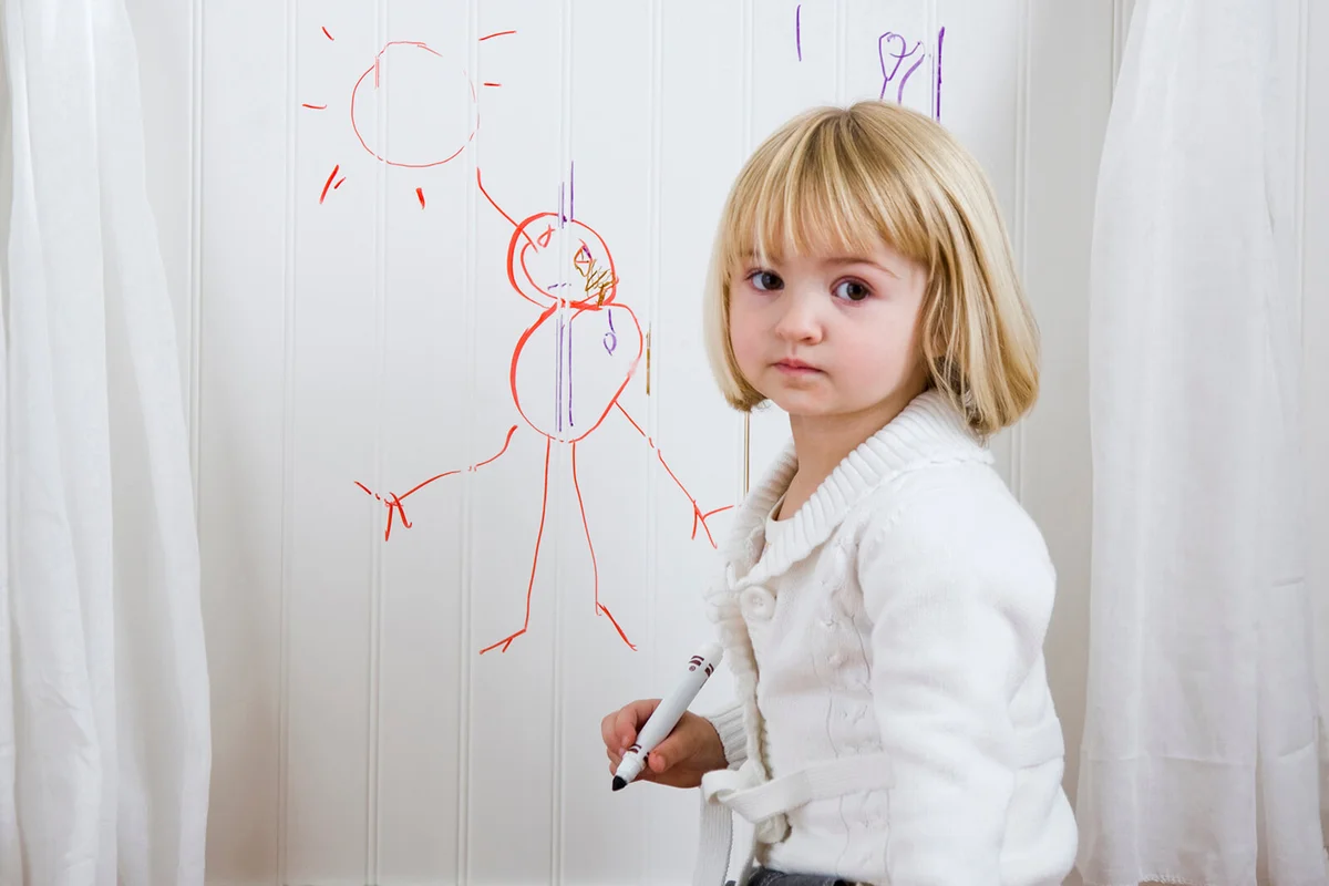 Child drawing on the wall