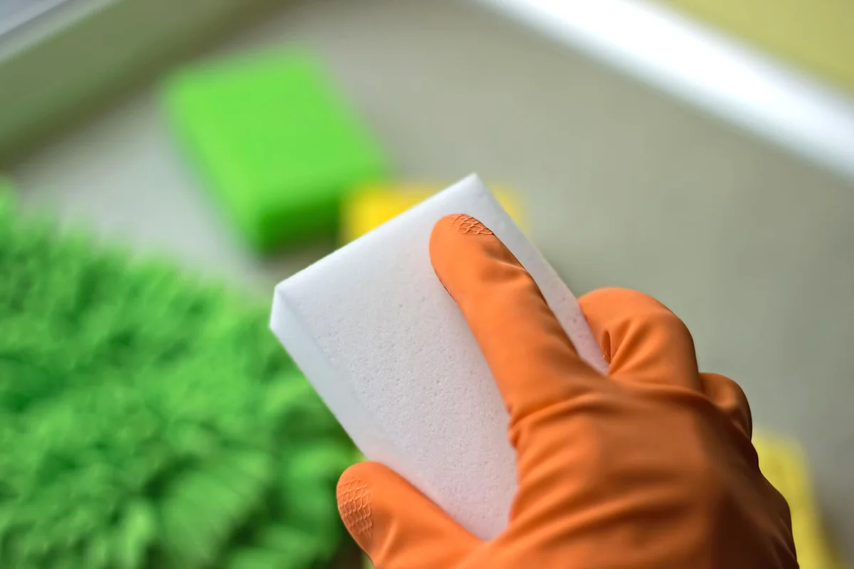 Melamine sponge in the hand close up