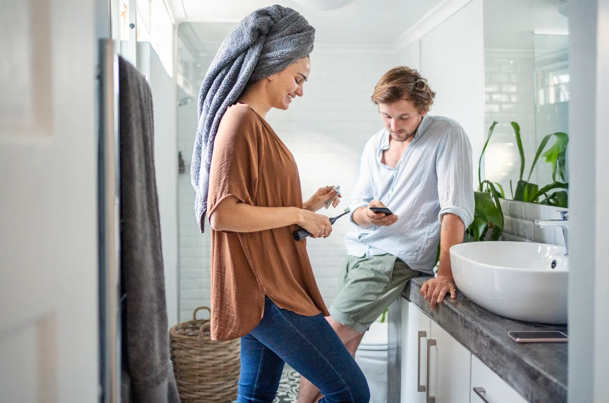 Young couple getting ready in their bathroom at home