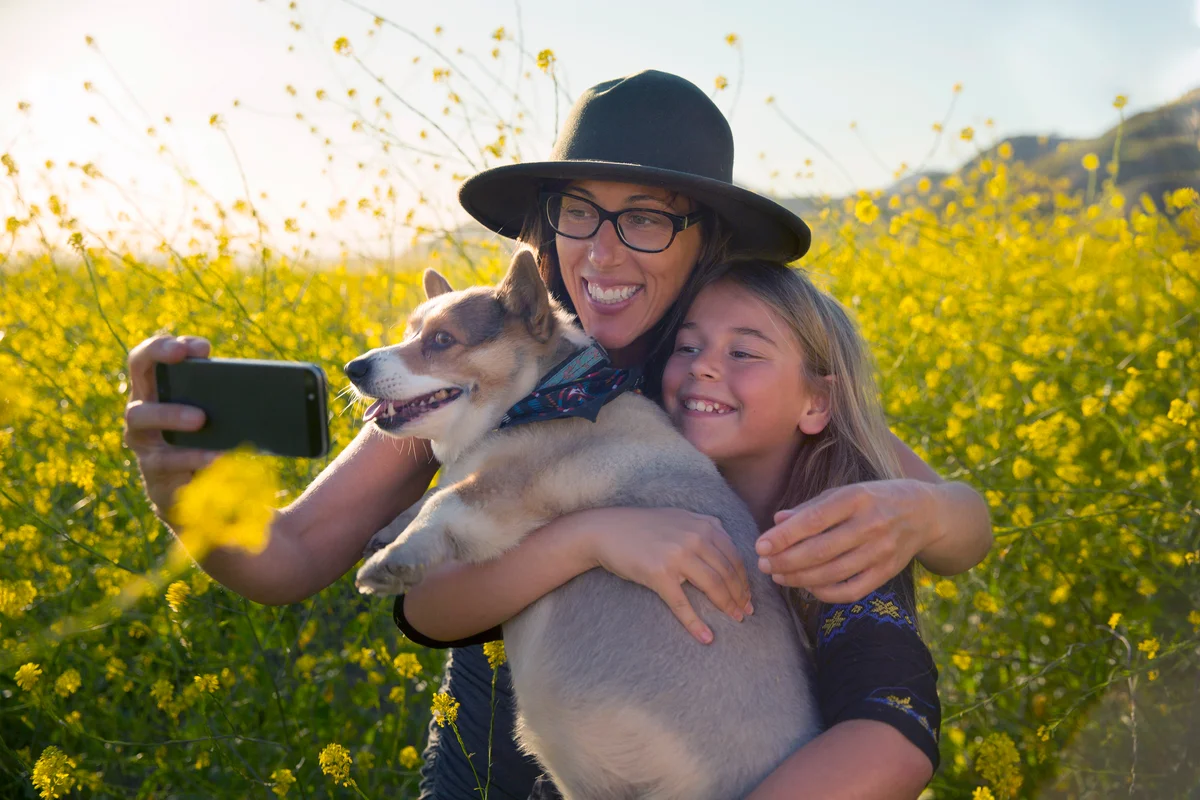 Mother and daughter with their corgi taking a selfie