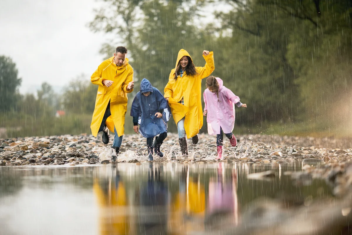Happy family in raincoats