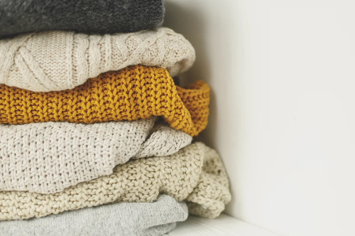 Close-up of folded sweaters on table