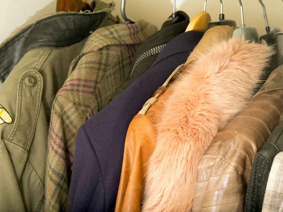 Expensive Mens Jackets Hanging In Clothes Cupboard