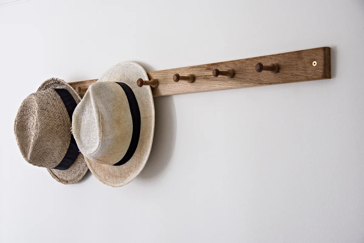 Hats hanging on hook on wall