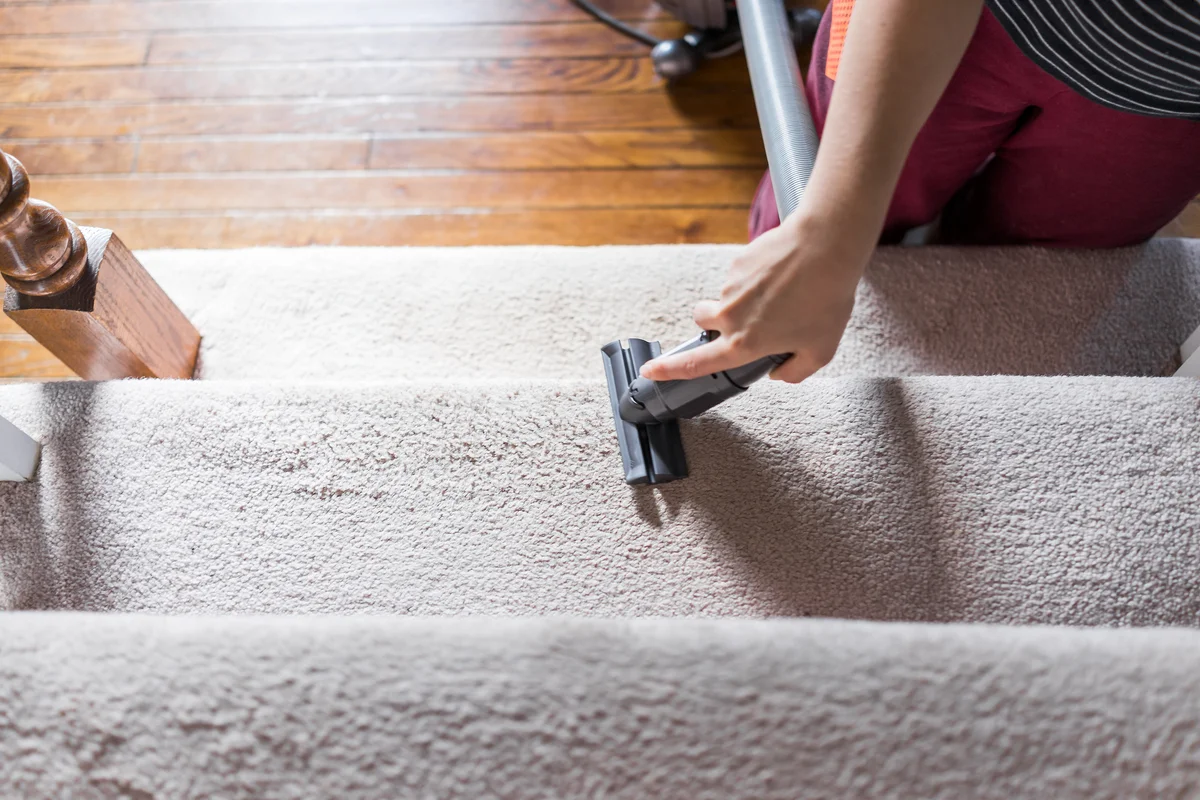 woman vacuuming stairs