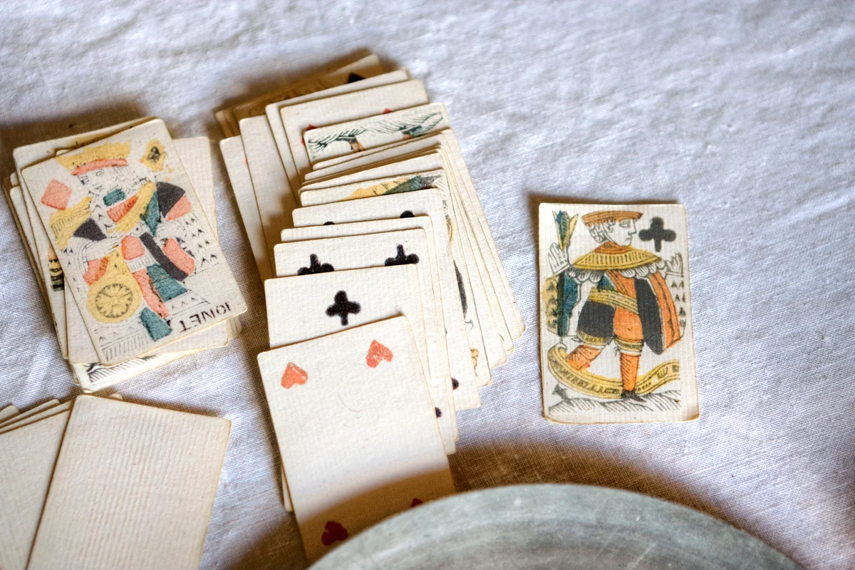Antique deck of cards on a white tablecloth