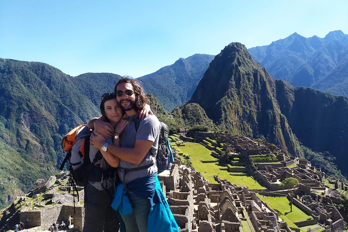 Couple of tourists at Machu Picchu, Peru