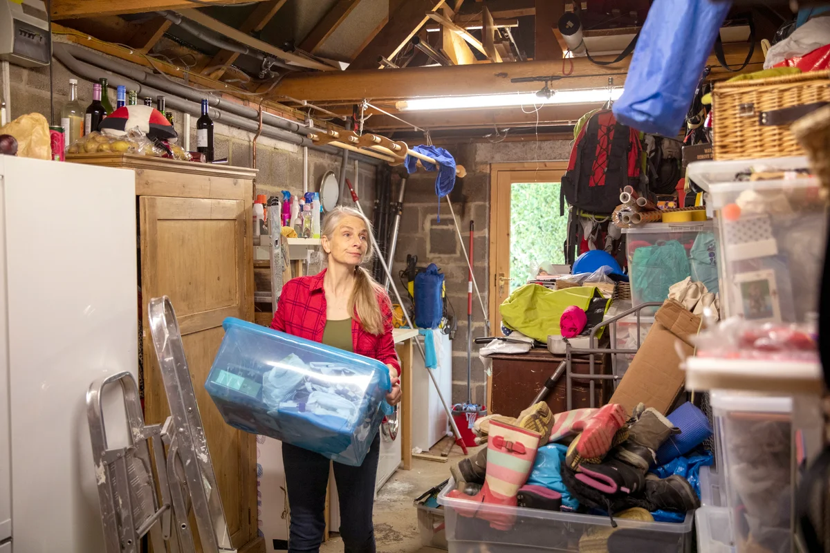 Woman tidying and decluttering the garage