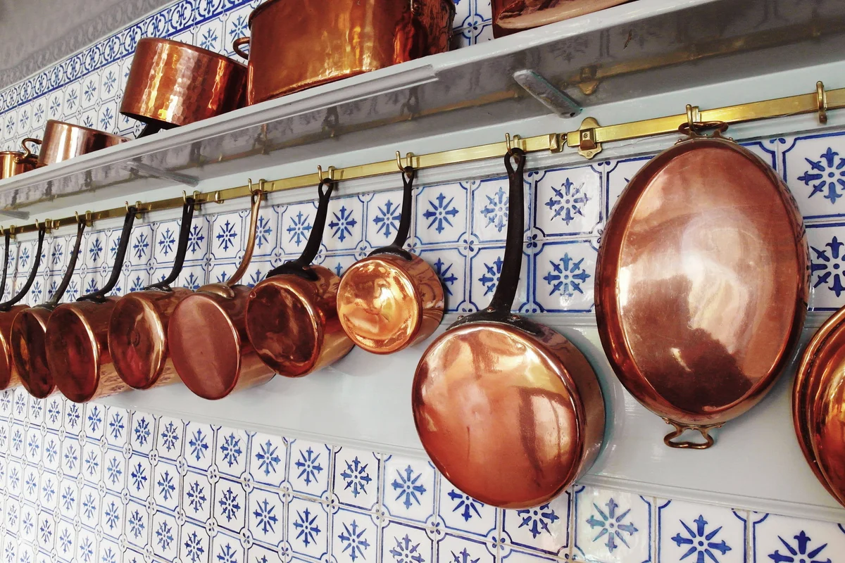 Copper utensils hanging on the wall