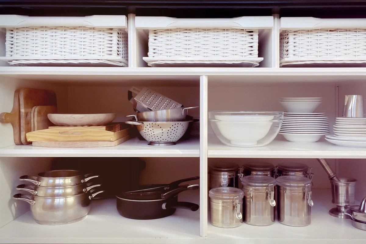 Containers And Ceramics Arranged In Shelves At Kitchen