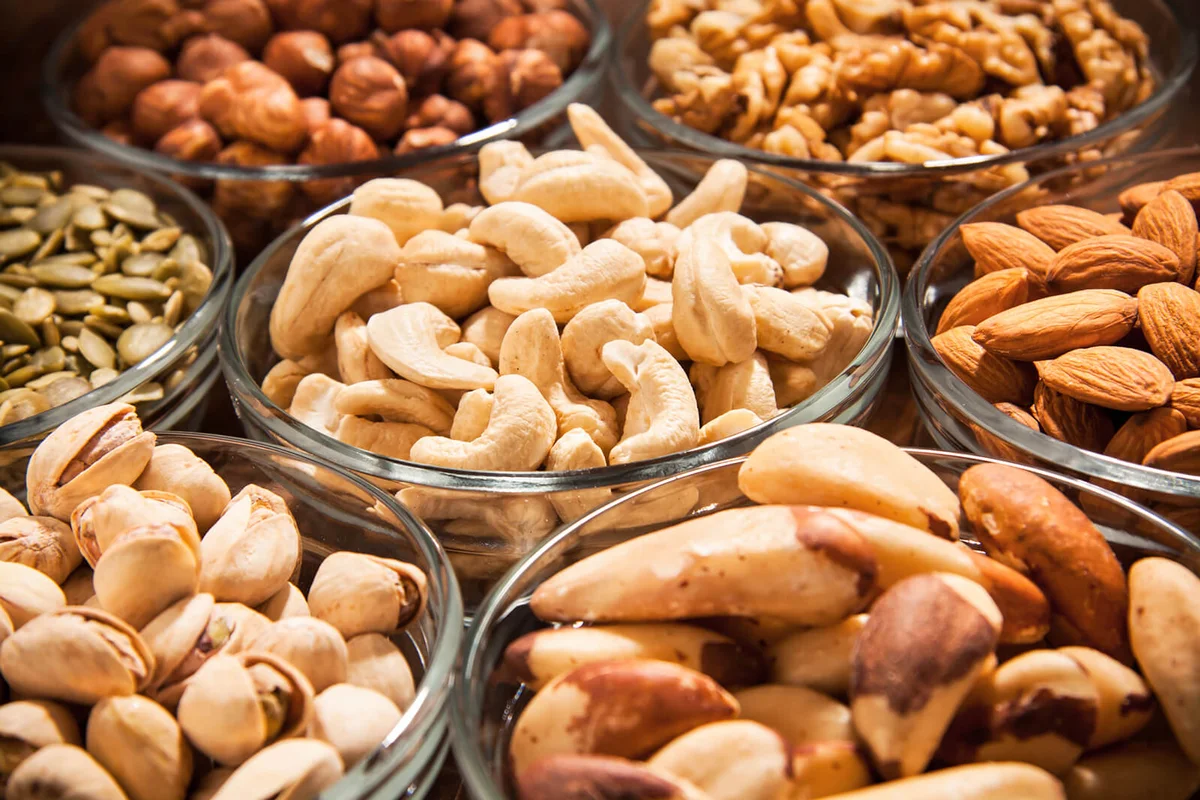 Various snacks,nuts,and dryed fruits in glass dish bowles