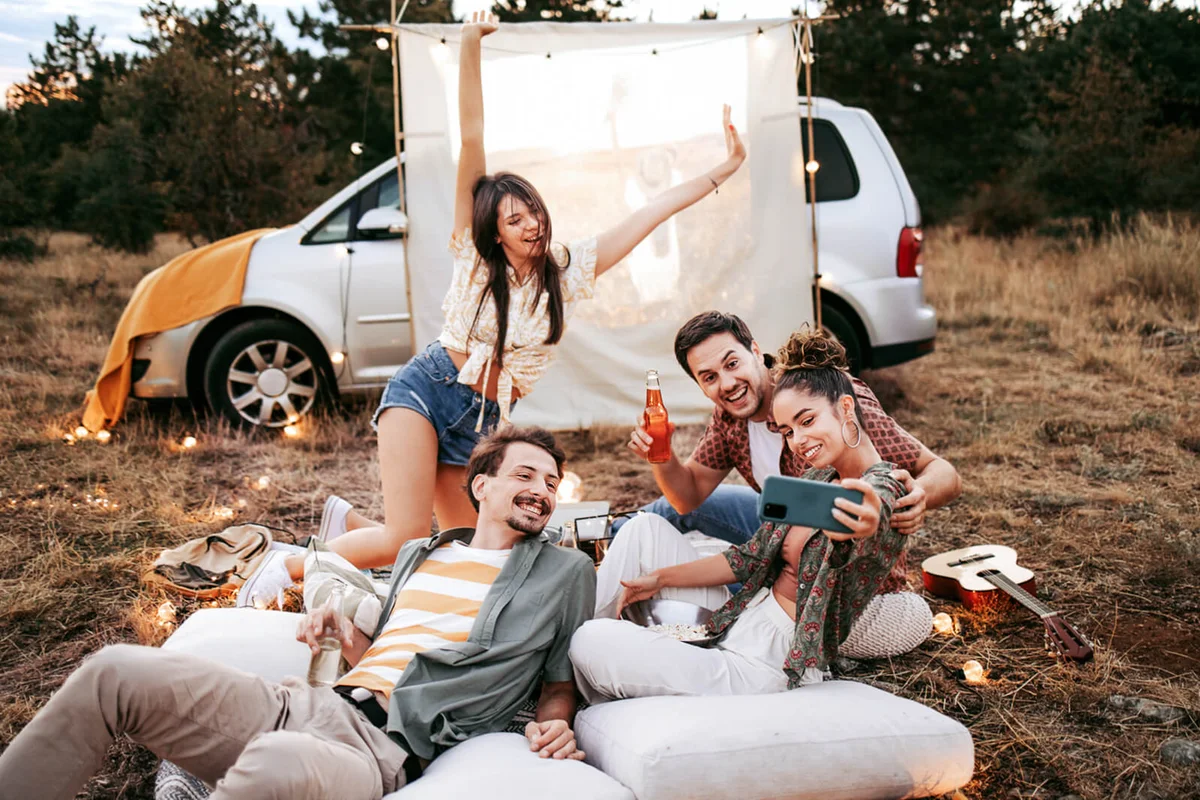 friends taking a selfie while having a movie night outdoor