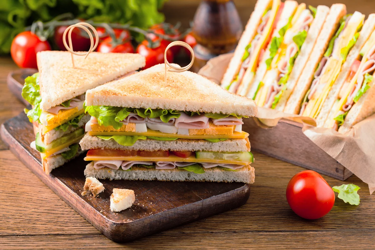 Delicious toast sandwich with ham, cheese, egg and vegetables