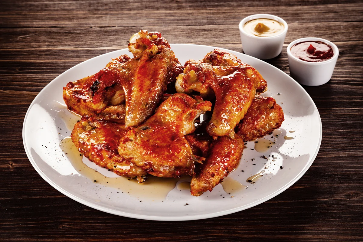 Barbecue chicken wings on wooden table