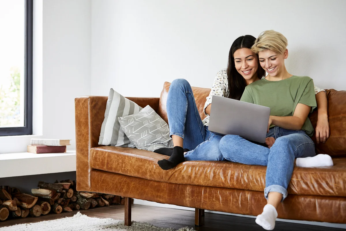 Lesbian couple watching movie on laptop