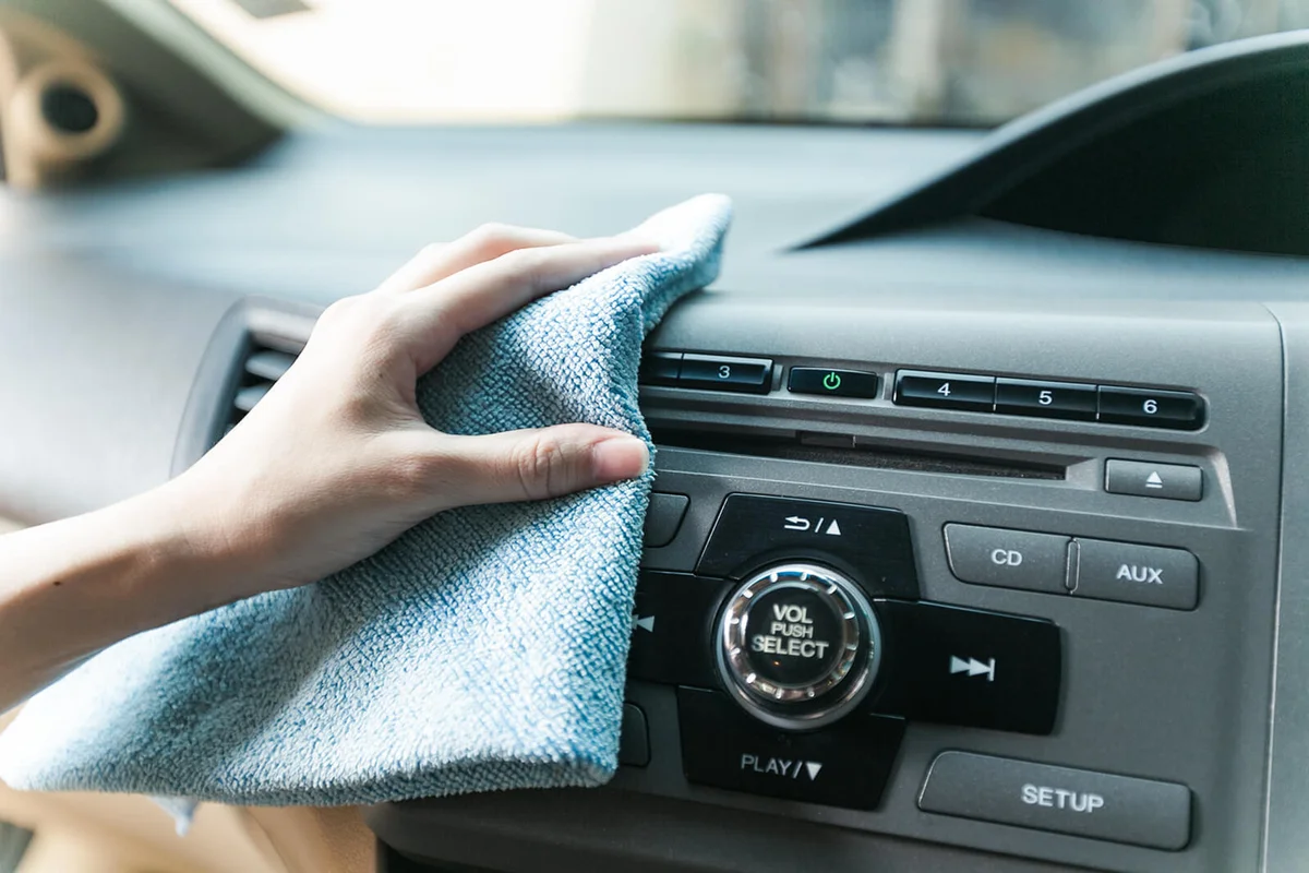 Woman Cleaning Dashboard