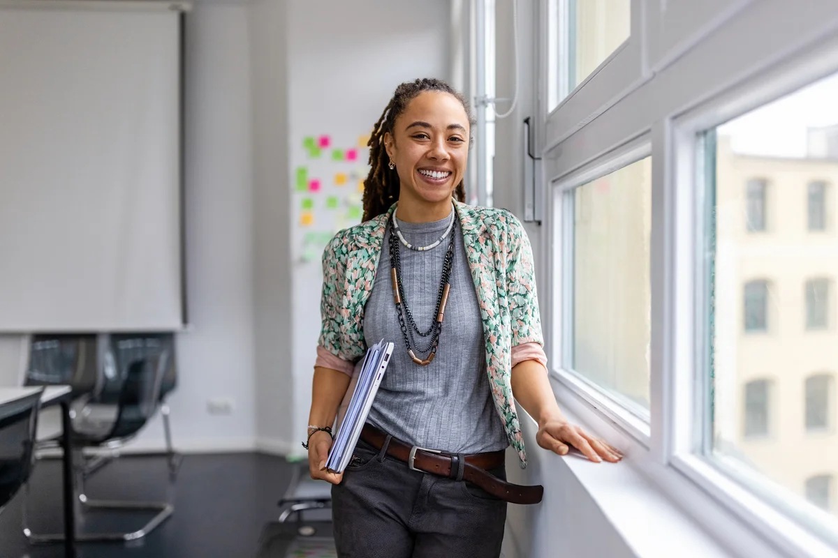 woman with gender-neutral style wearing long wood and black chained necklace