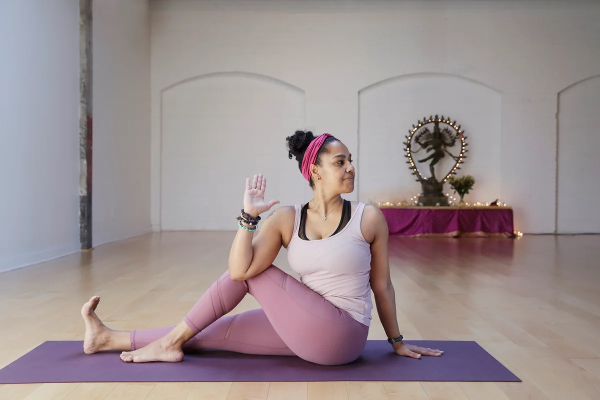 woman doing yoga, wearing pendant necklace