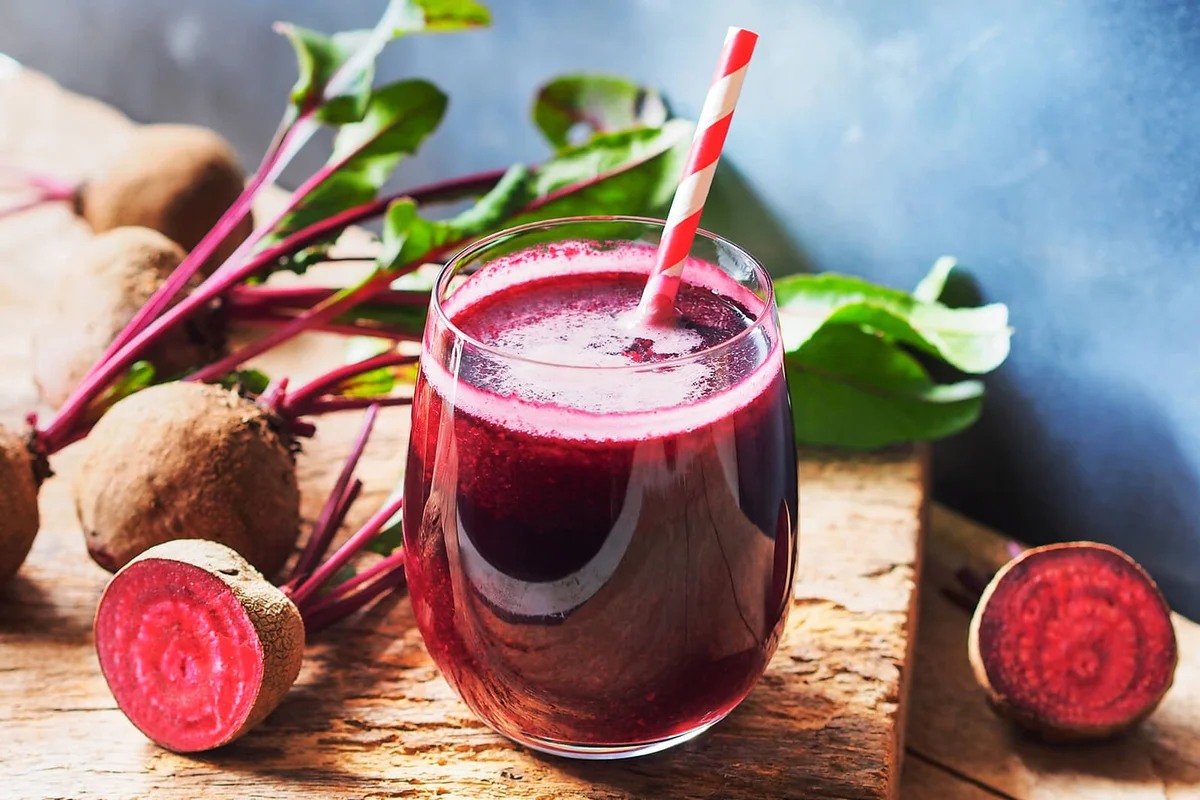 Beetroot juice in glass and fresh organics beetroot