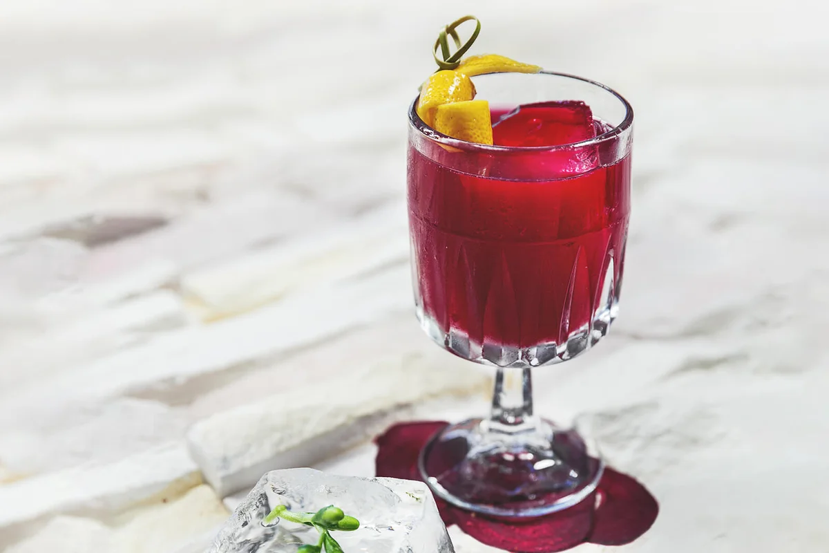 Garnished cocktail on white background