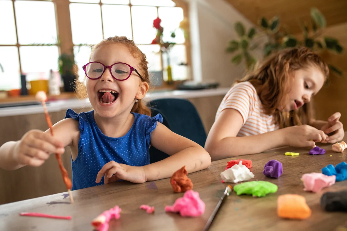 two young girls playing with playdough
