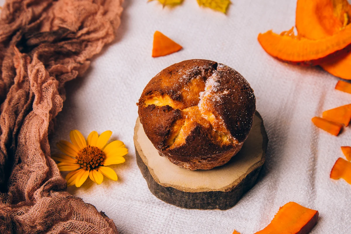 pumpkin spice muffin in rustic setting