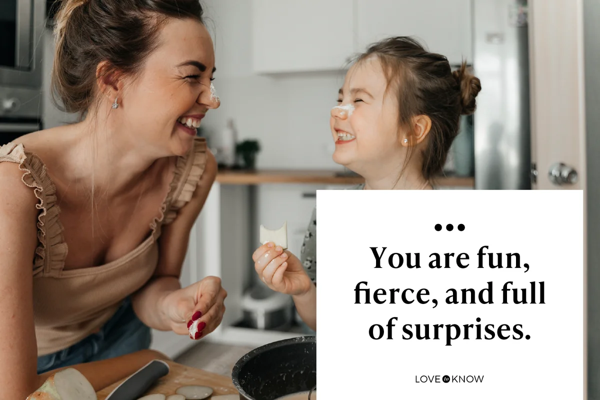 Playful mother and daughter preparing food together in kitchen