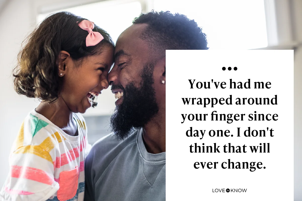 Father and daughter laughing in bedroom