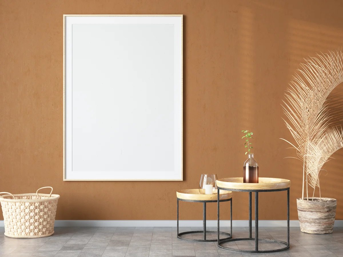 Empty picture frame on caramel-colored wall