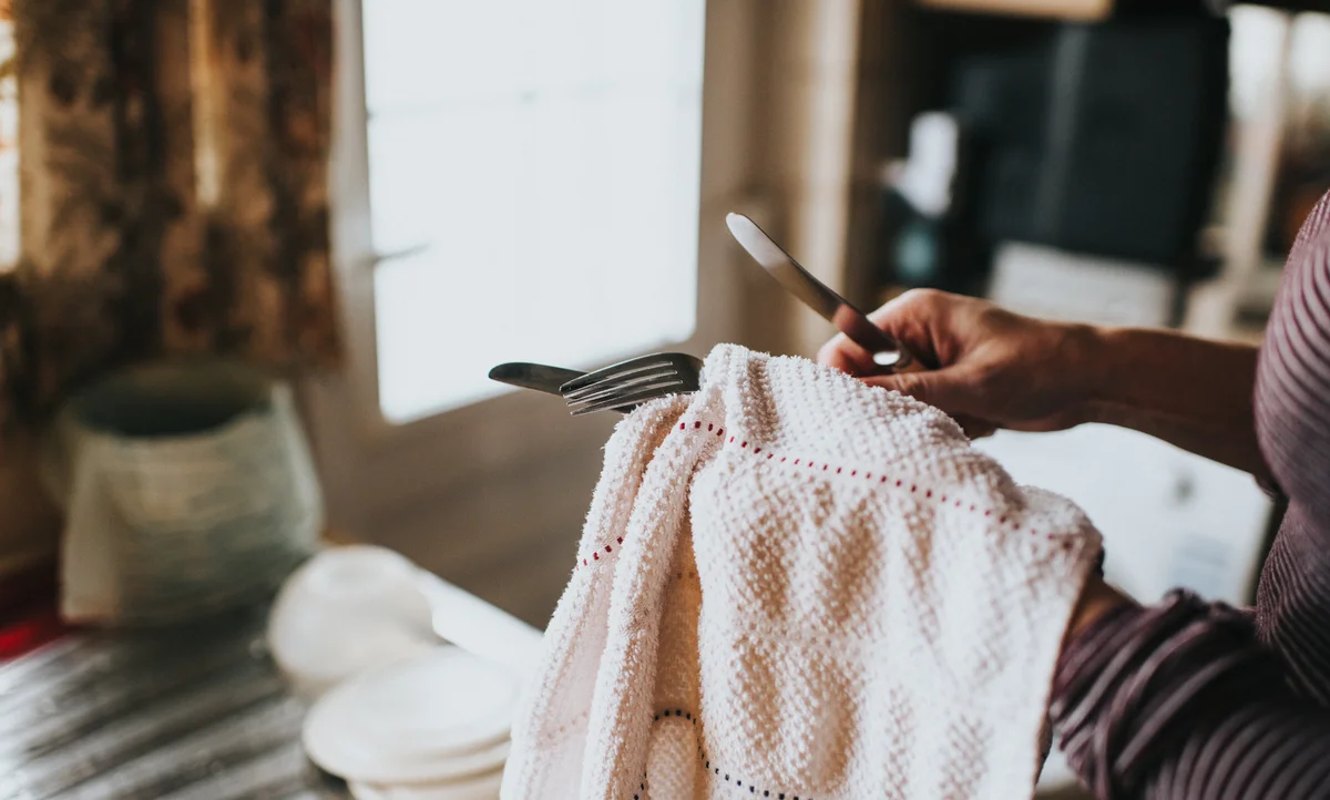 woman polishing silver flatware