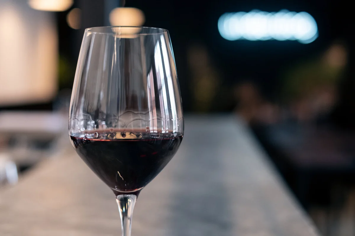 glass of red wine on a bar counter