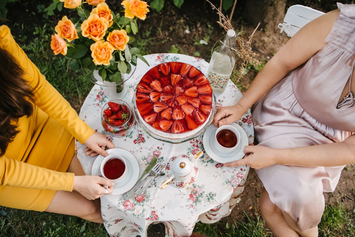 overhead shot of two women having tea in the garden