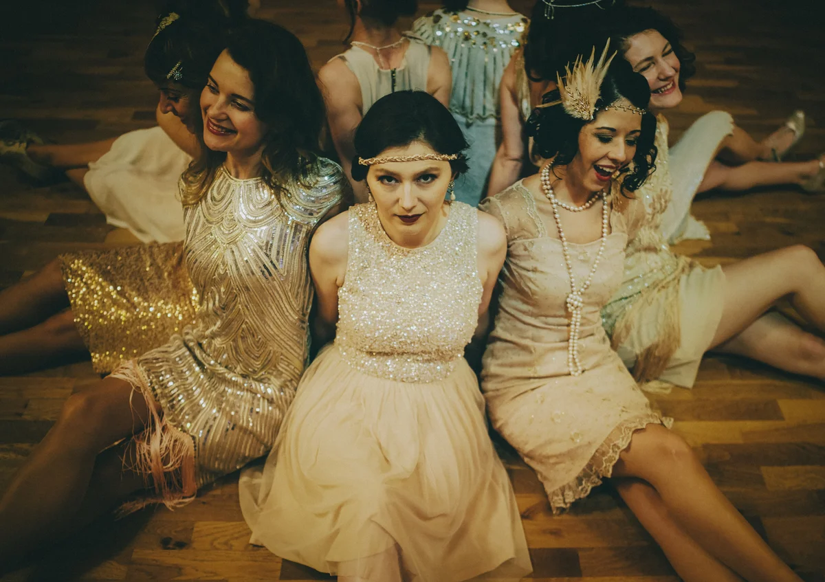group of women dressed in 1920s flapper outfits