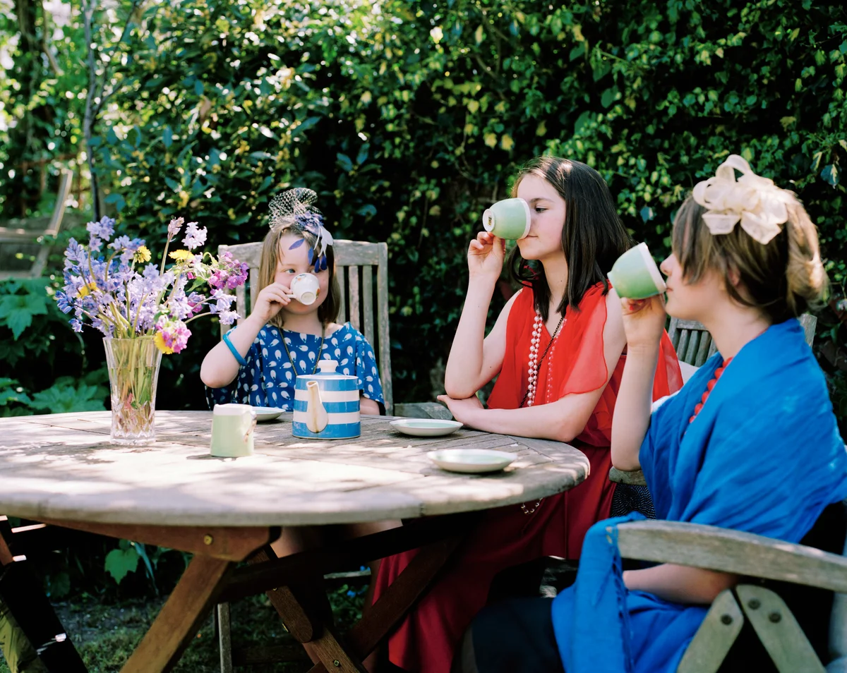 Three girls drinking tea