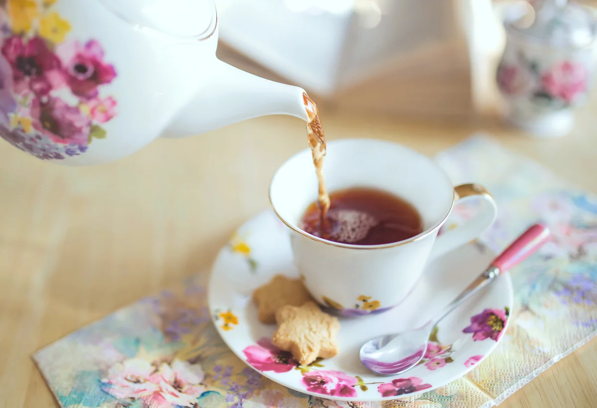 pouring tea into a teacup