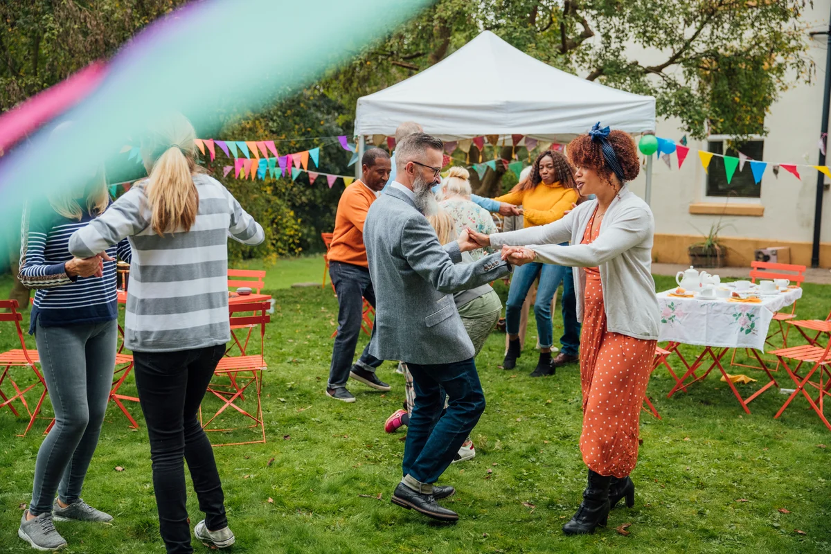 people dancing in the yard at a party