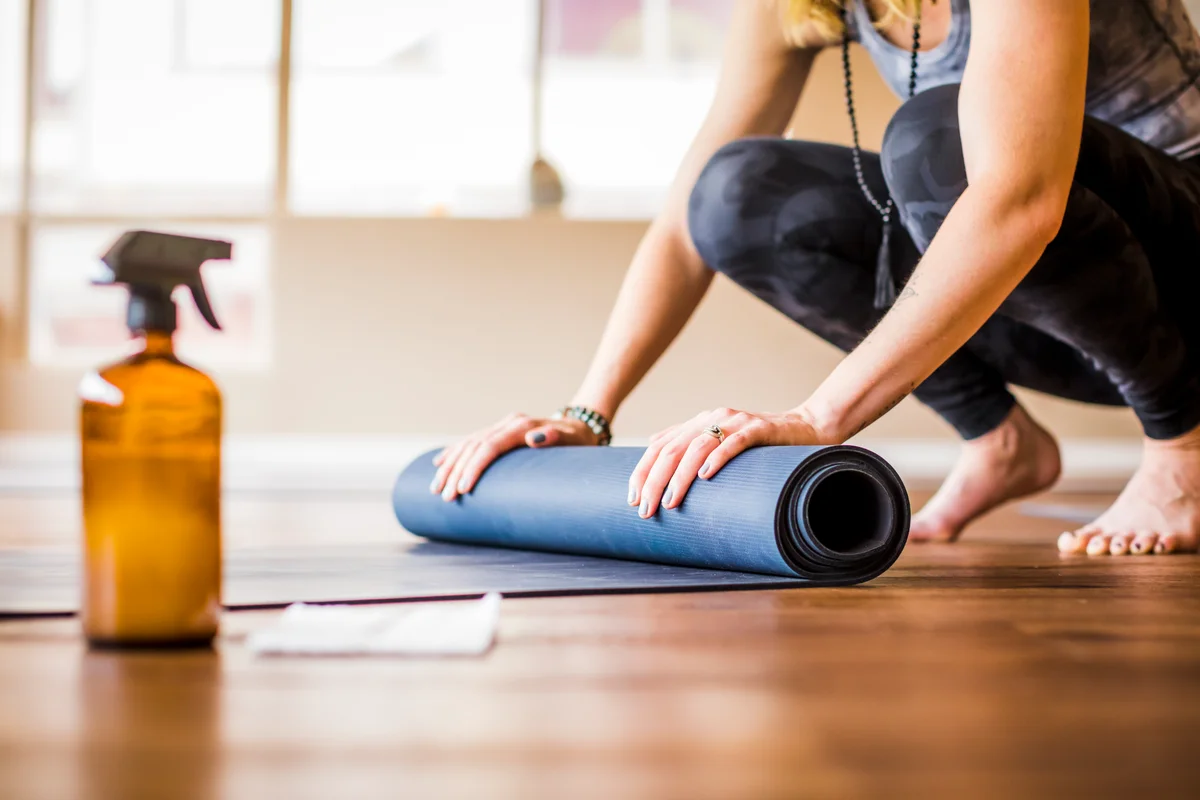 woman rolling yoga mat