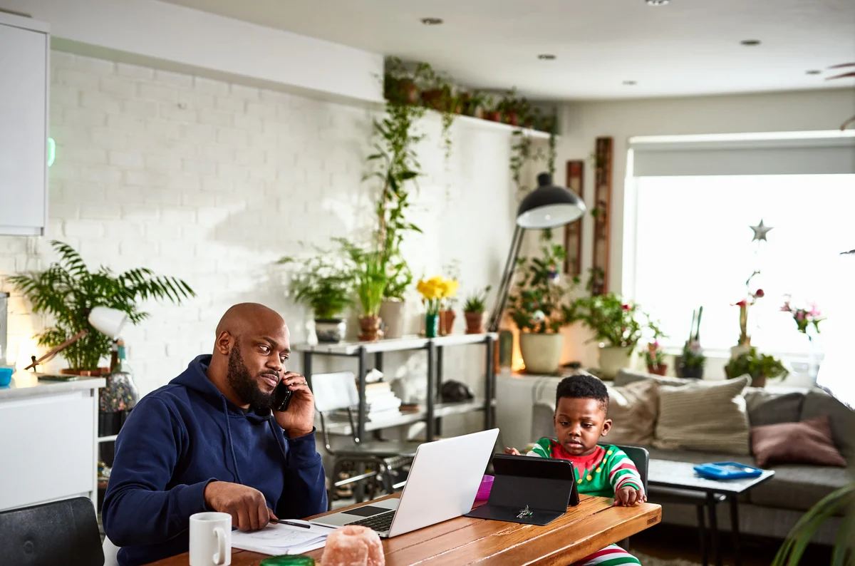 dad and son on their devices at the table