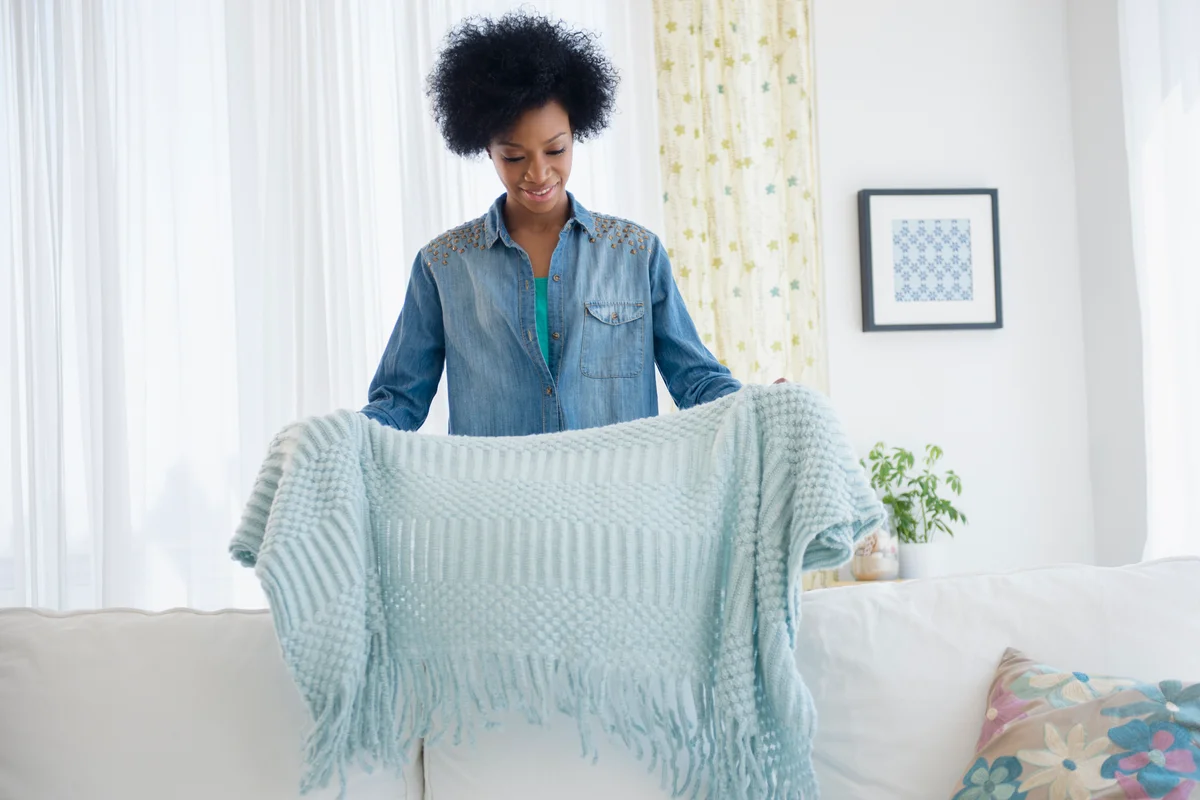 woman folding blanket