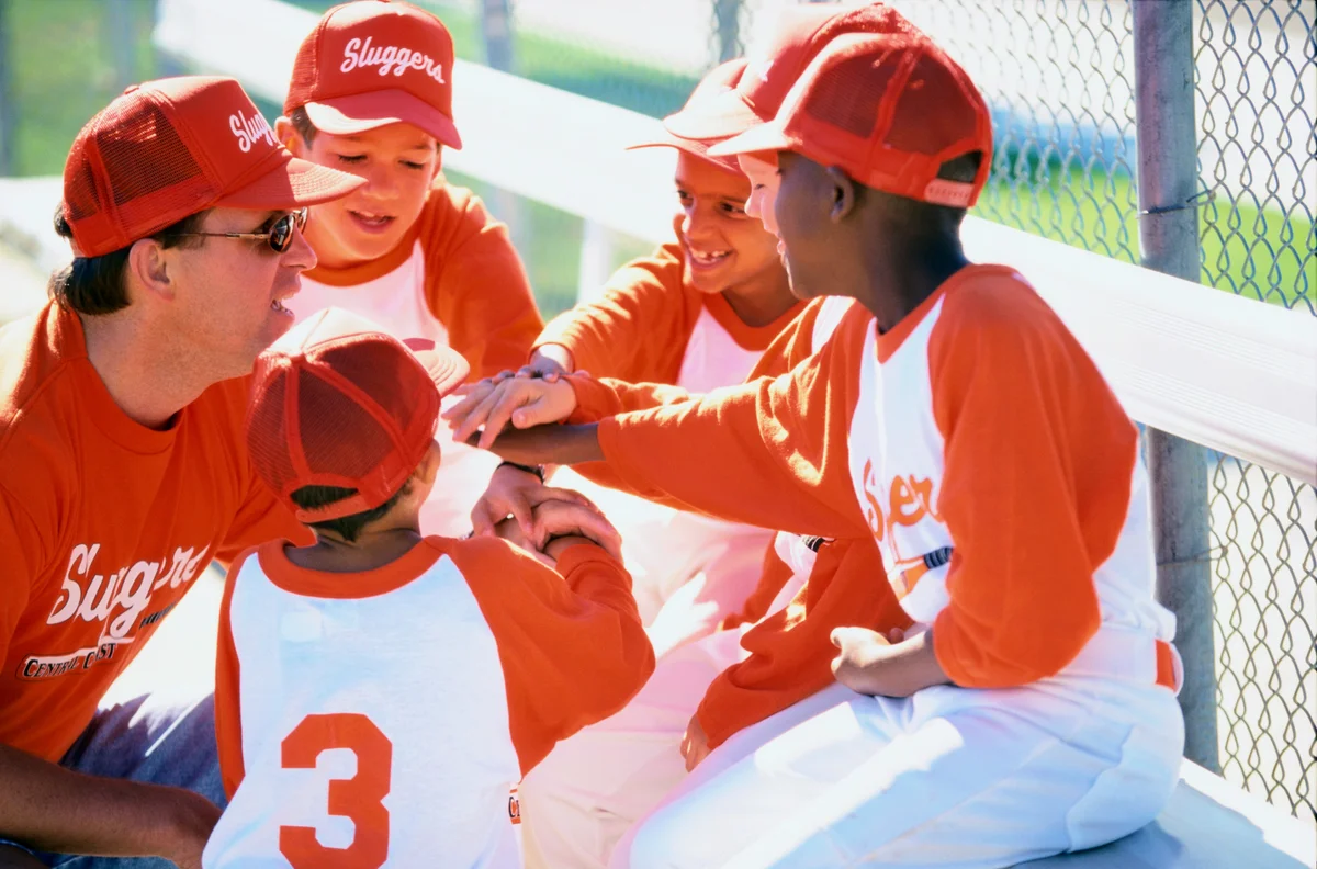little league baseball team with coach