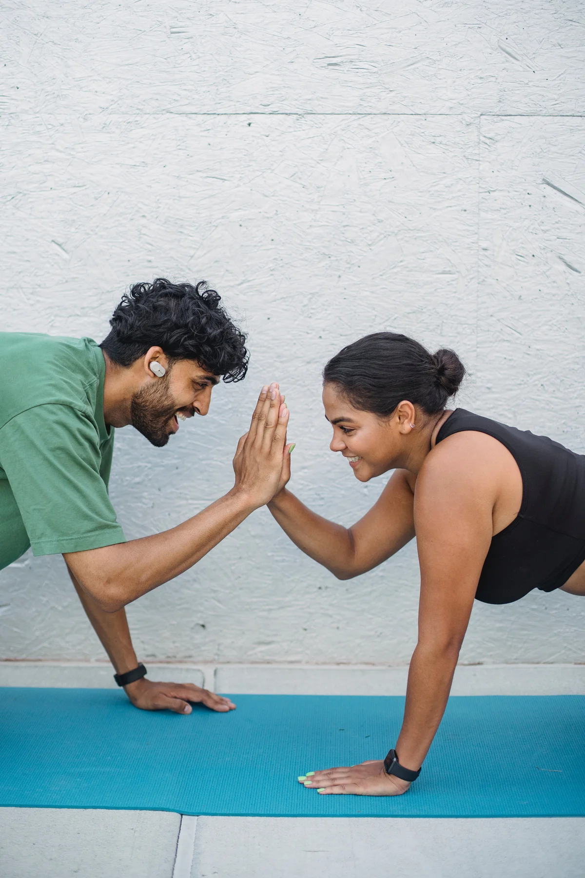 couple working out giving high five