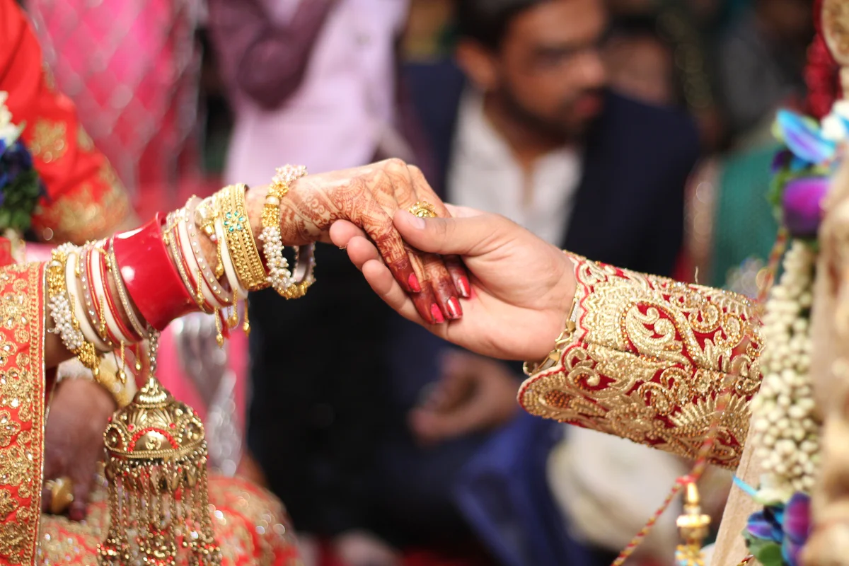couple holding hands at an Indian wedding
