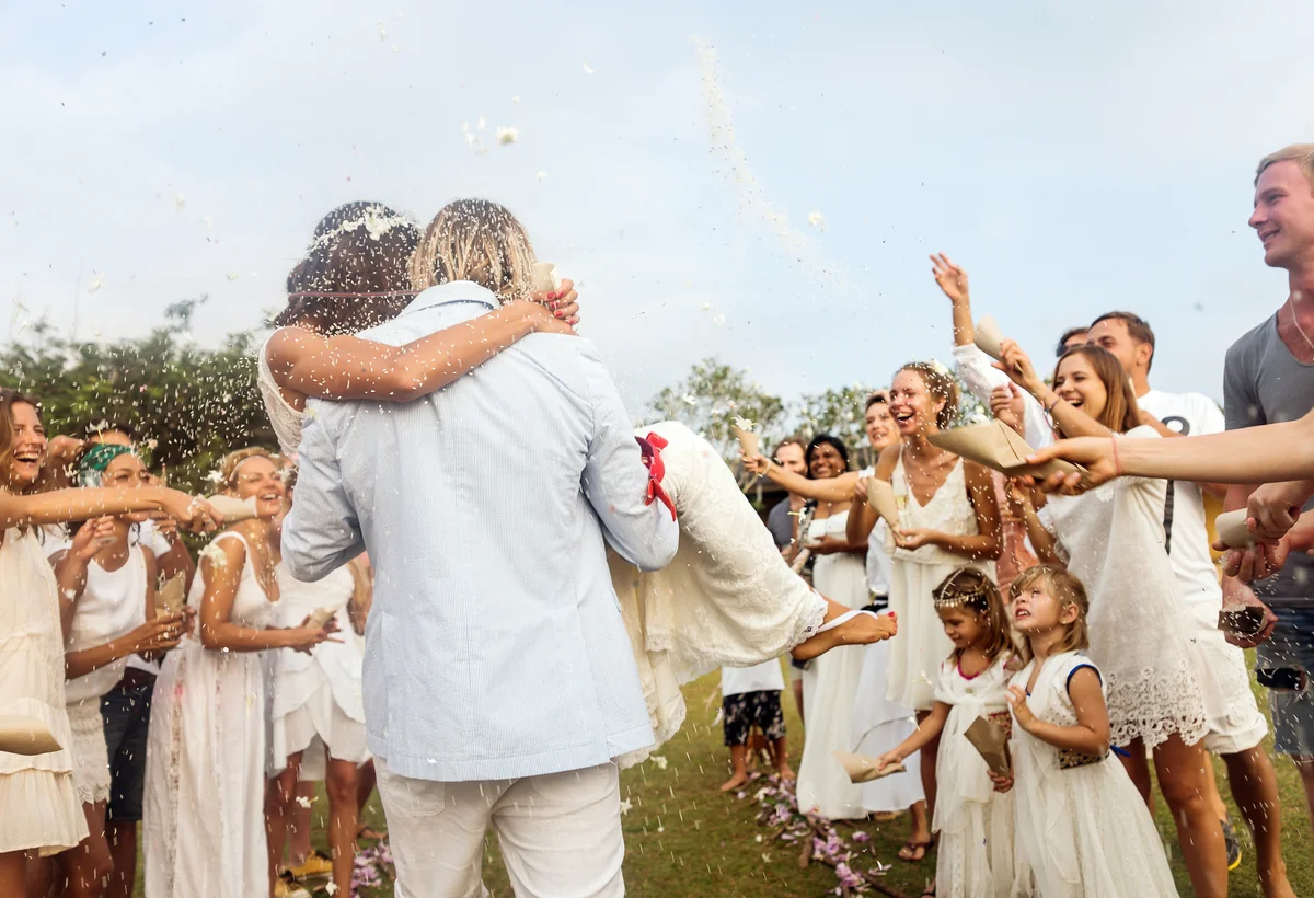 guests throwing rice at a wedding