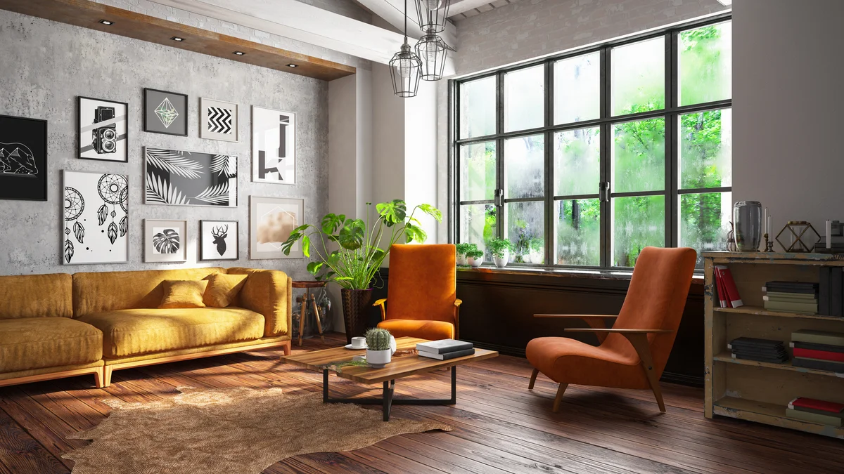 Loft room with cozy design, yellow couch, orange chairs and black and white gallery wall