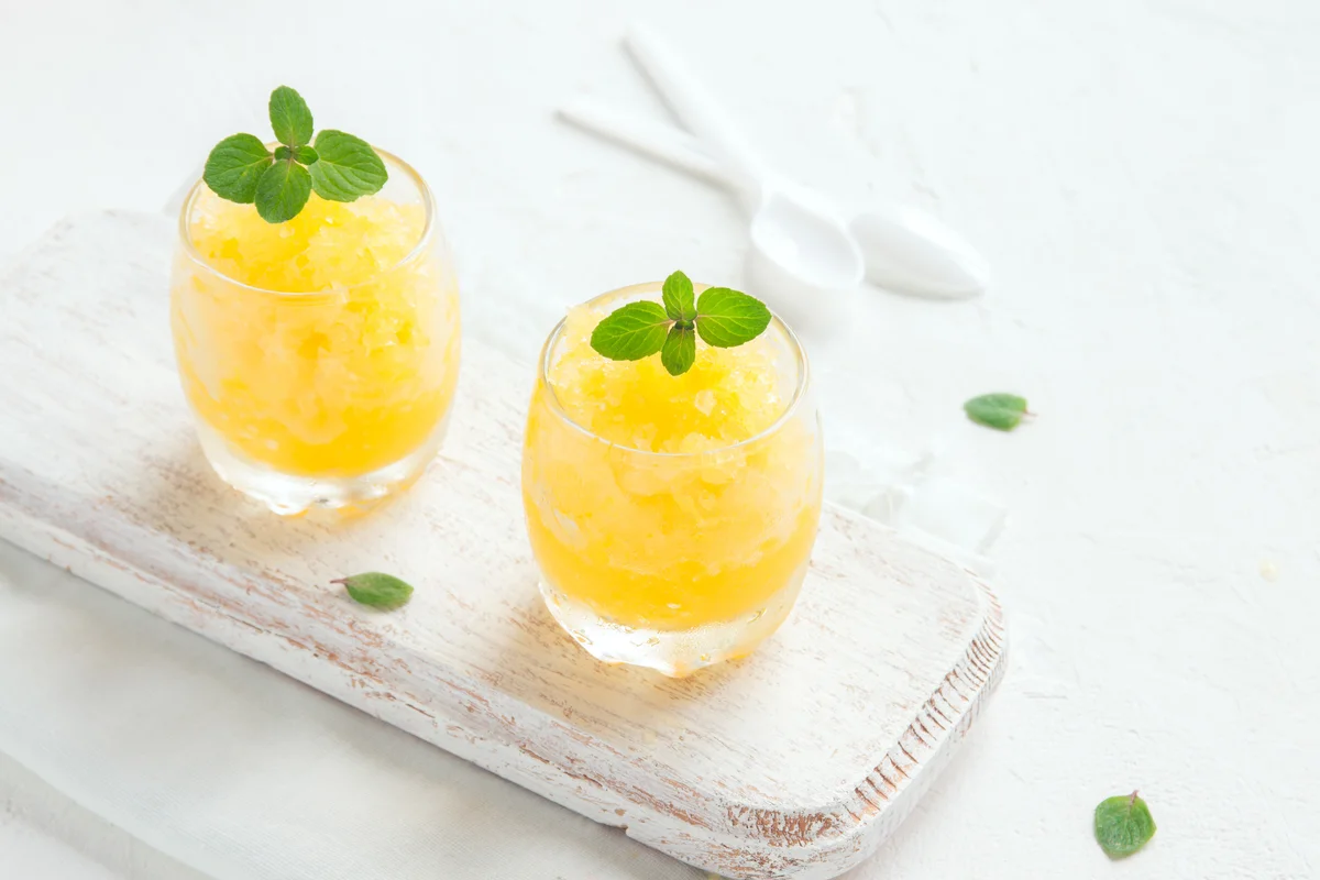Frozen lemon drink on white table.
